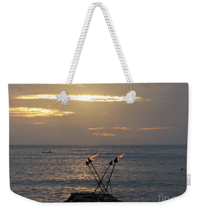 Tiki Torches On The Waters Edge In Waikiki Weekender Tote Bag featuring the photograph Tiki Torches in the Sunset by Anthony Trillo