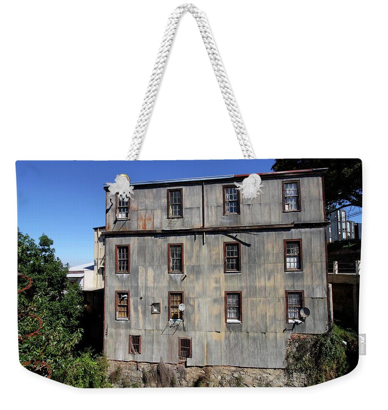 Rusty Weekender Tote Bag featuring the photograph Tin Building On The Hillside by Aidan Moran