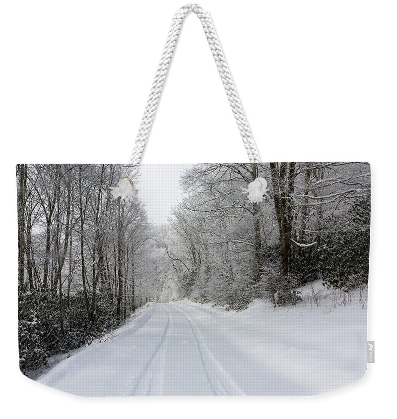 Snow Weekender Tote Bag featuring the photograph Tire Tracks In Fresh Snow by D K Wall