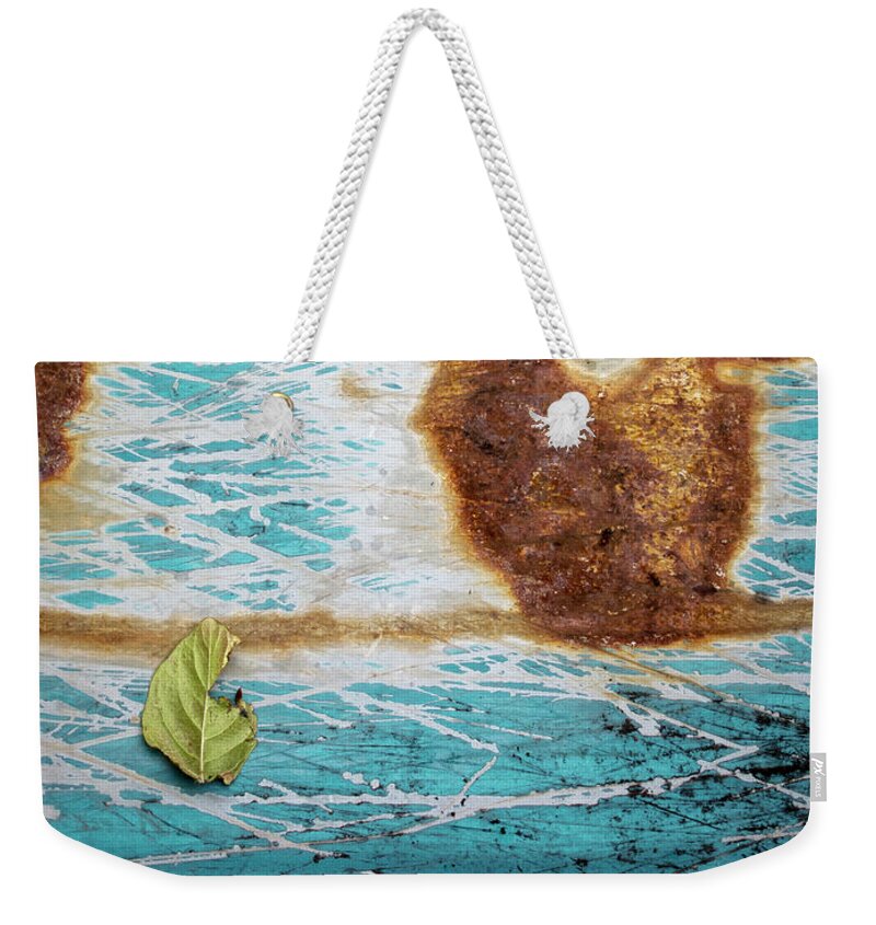 Abstract Weekender Tote Bag featuring the photograph Torn Leaf on Rusted Metal by Mary Lee Dereske