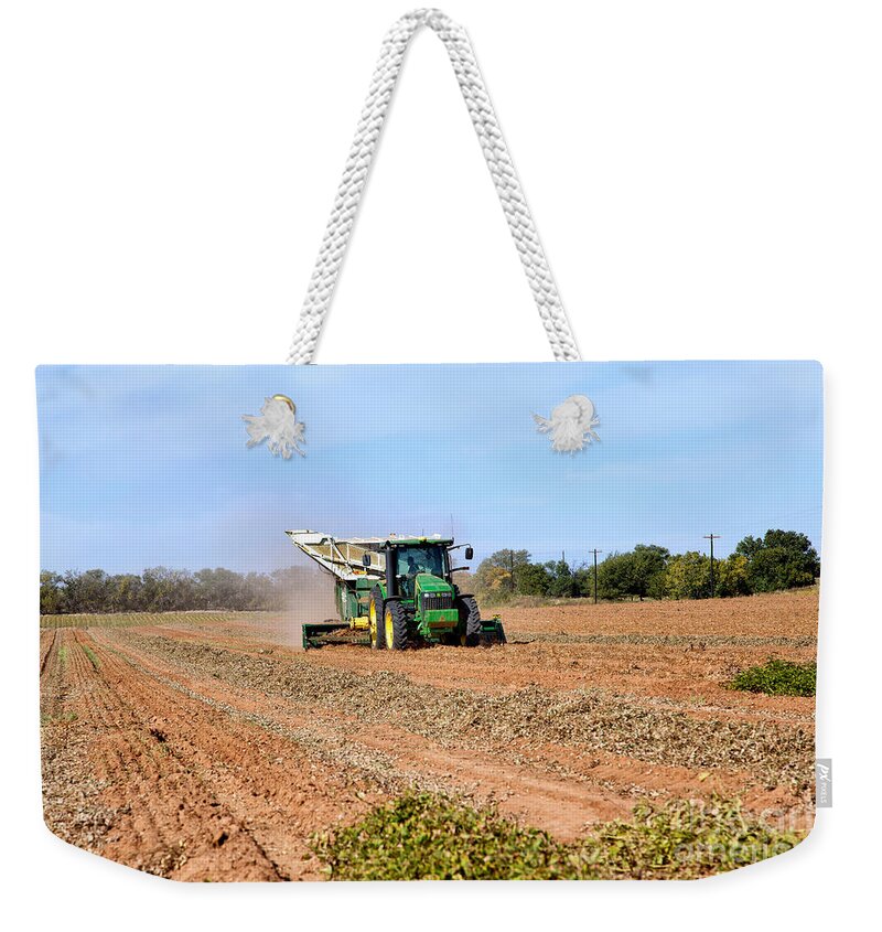Arachis Hypogaea Weekender Tote Bag featuring the photograph Tractor Harvesting Inverted Peanut Crop by Inga Spence