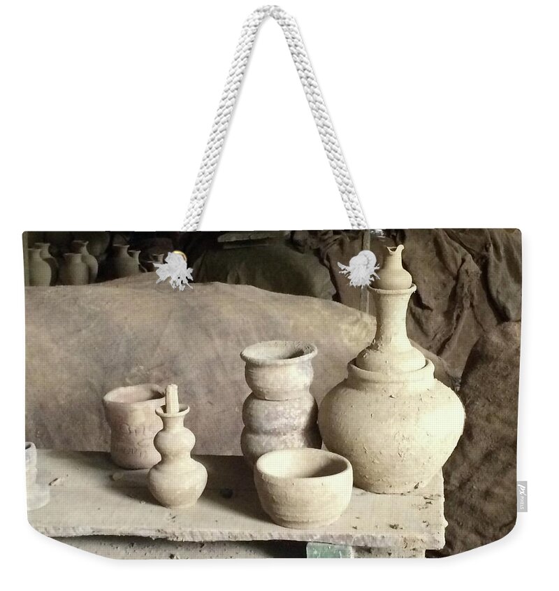  Weekender Tote Bag featuring the photograph Traditional craft work. by Christopher Rowlands