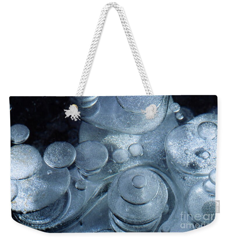 Winter Weekender Tote Bag featuring the photograph Trapped air bubbles in ice by Heiko Koehrer-Wagner