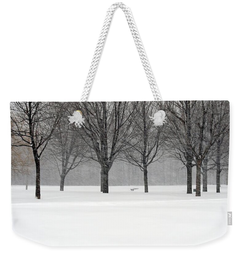 Winter Weekender Tote Bag featuring the photograph Trees during winter blizzard by GoodMood Art