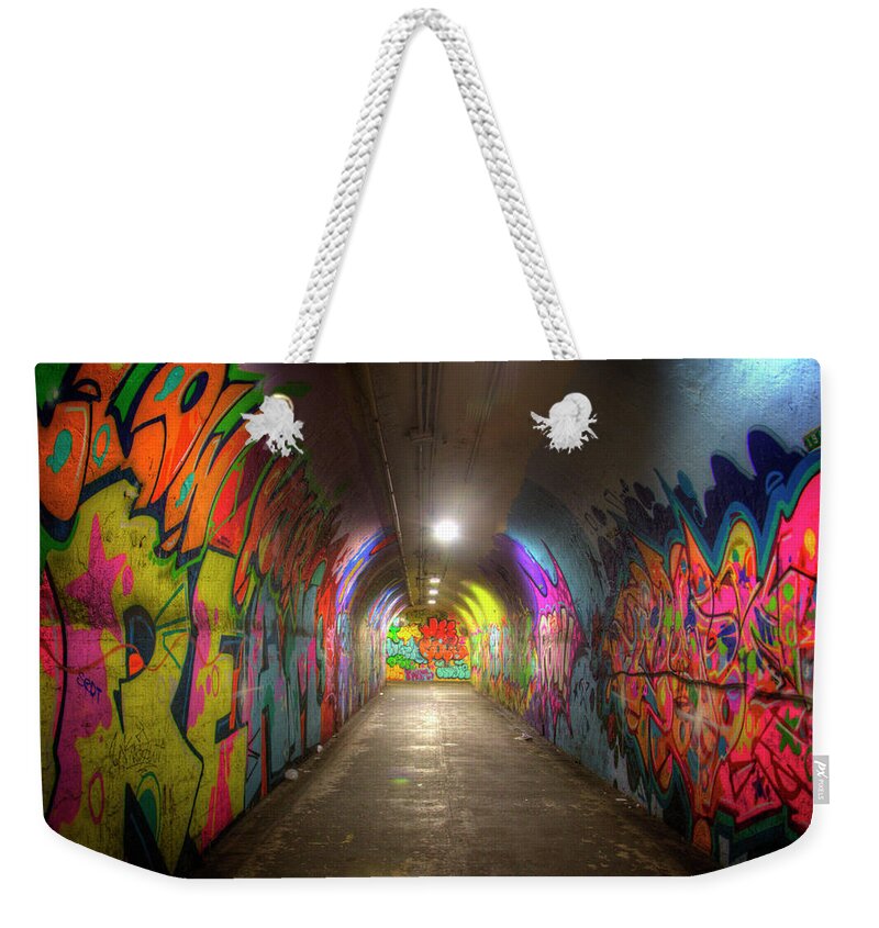 New York Weekender Tote Bag featuring the photograph Tunnel of Graffiti by Mark Andrew Thomas