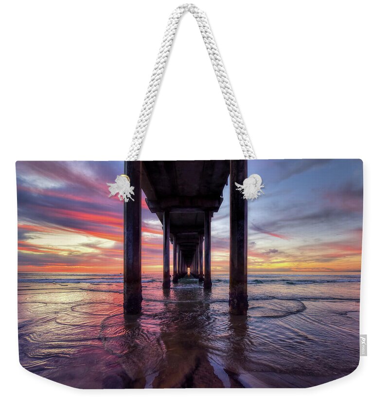 Mark Whitt Weekender Tote Bag featuring the photograph Under the Pier Sunset by Mark Whitt