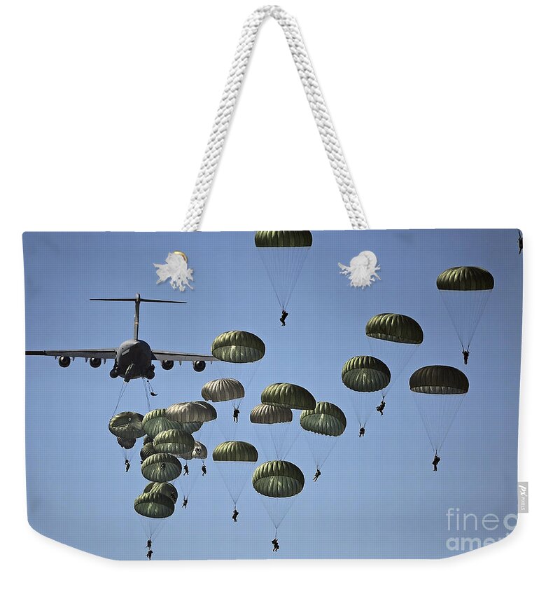Parachutist Weekender Tote Bag featuring the photograph U.s. Army Paratroopers Jumping by Stocktrek Images