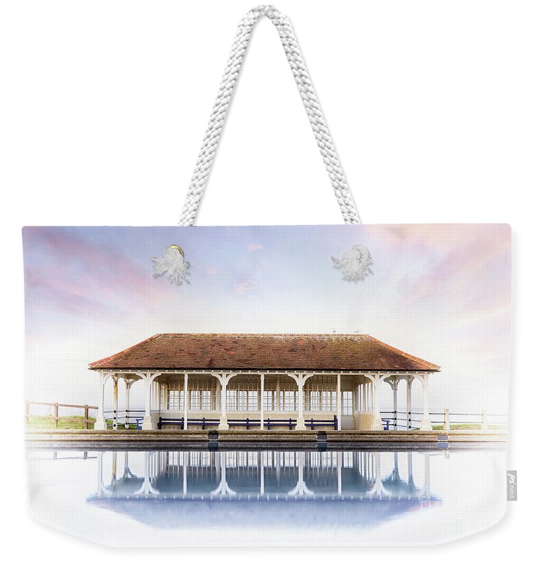 Sheringham Weekender Tote Bag featuring the photograph Norfolk victorian seaside shelter with pink sunset sky by Simon Bratt