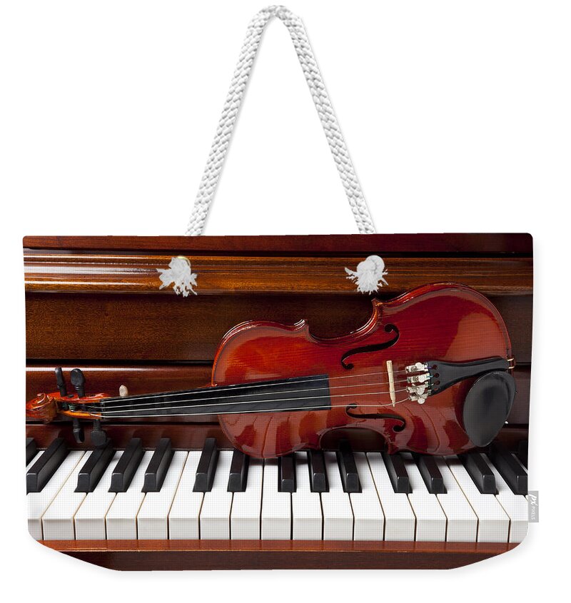 Violin Weekender Tote Bag featuring the photograph Violin on piano by Garry Gay