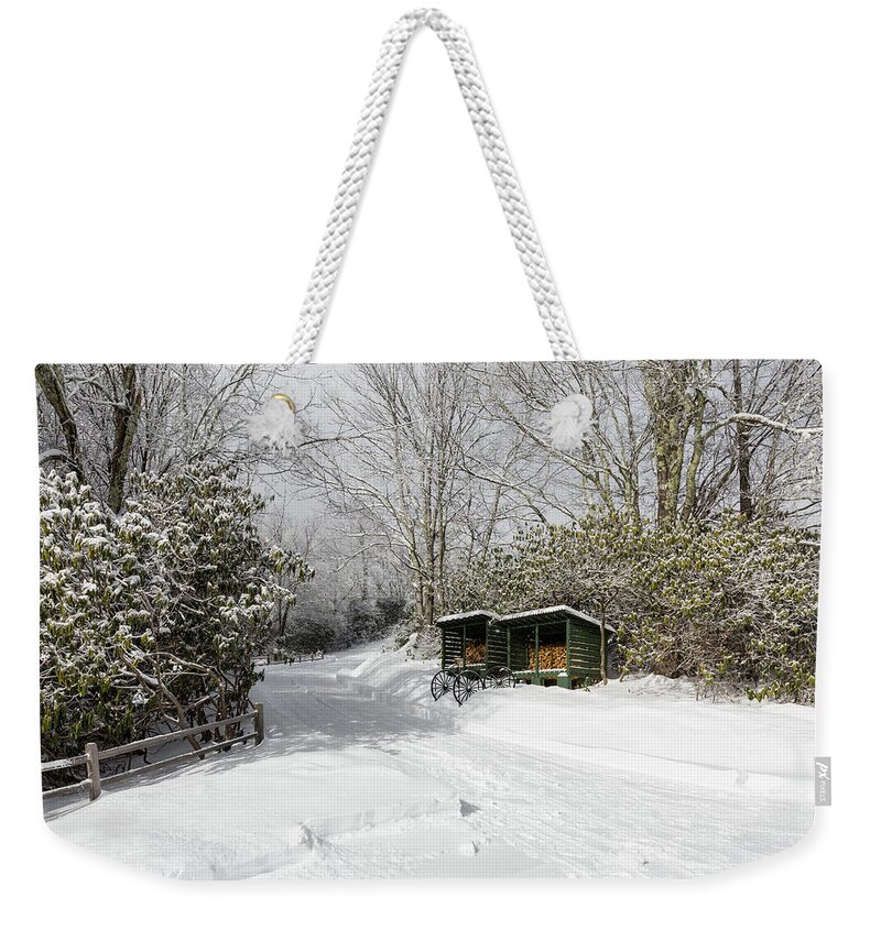 Snow Weekender Tote Bag featuring the photograph Wagon Wheels and Firewood by D K Wall