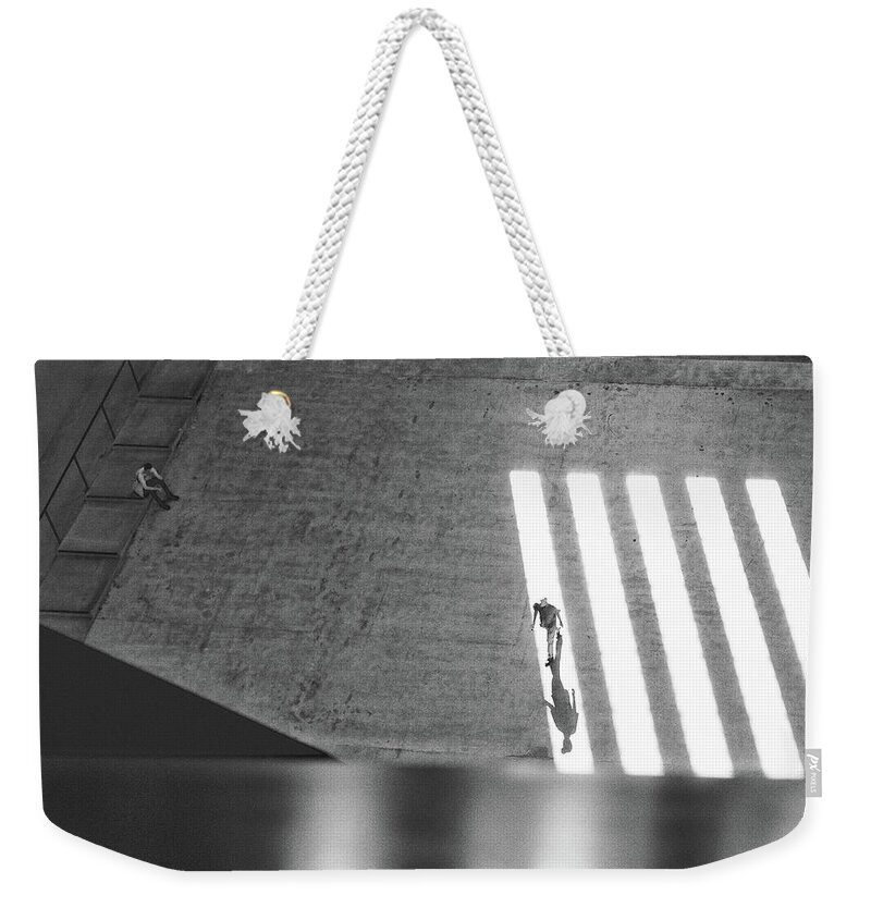 Black And White Weekender Tote Bag featuring the photograph Walking in the light by Lora Lee Chapman