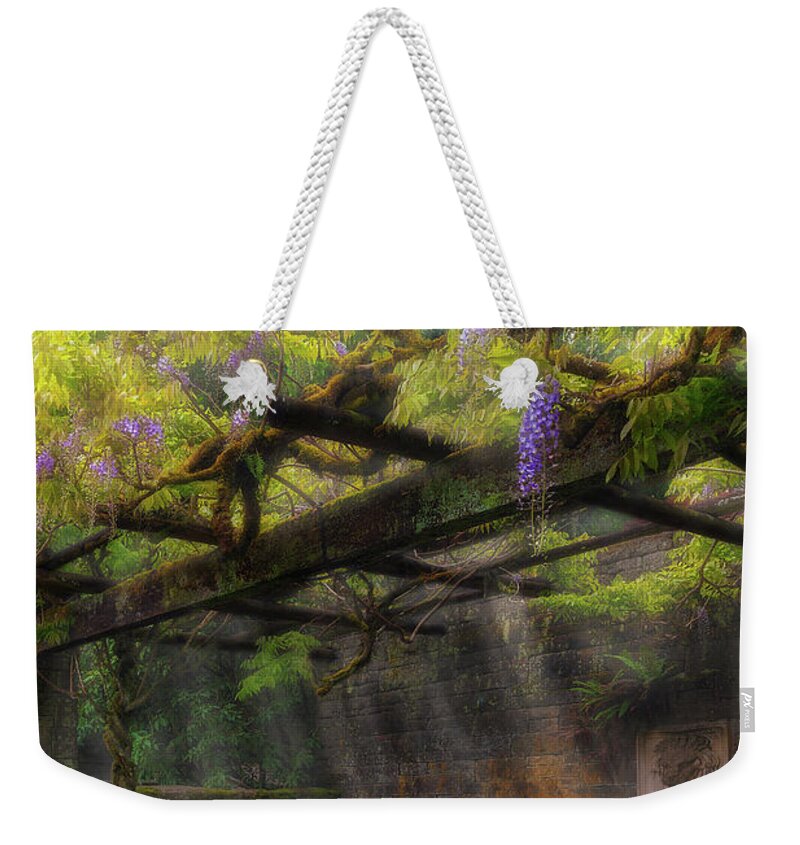 Garden Weekender Tote Bag featuring the photograph Wisteria Flowers Blooming on Trellis over Water Fountain by David Gn