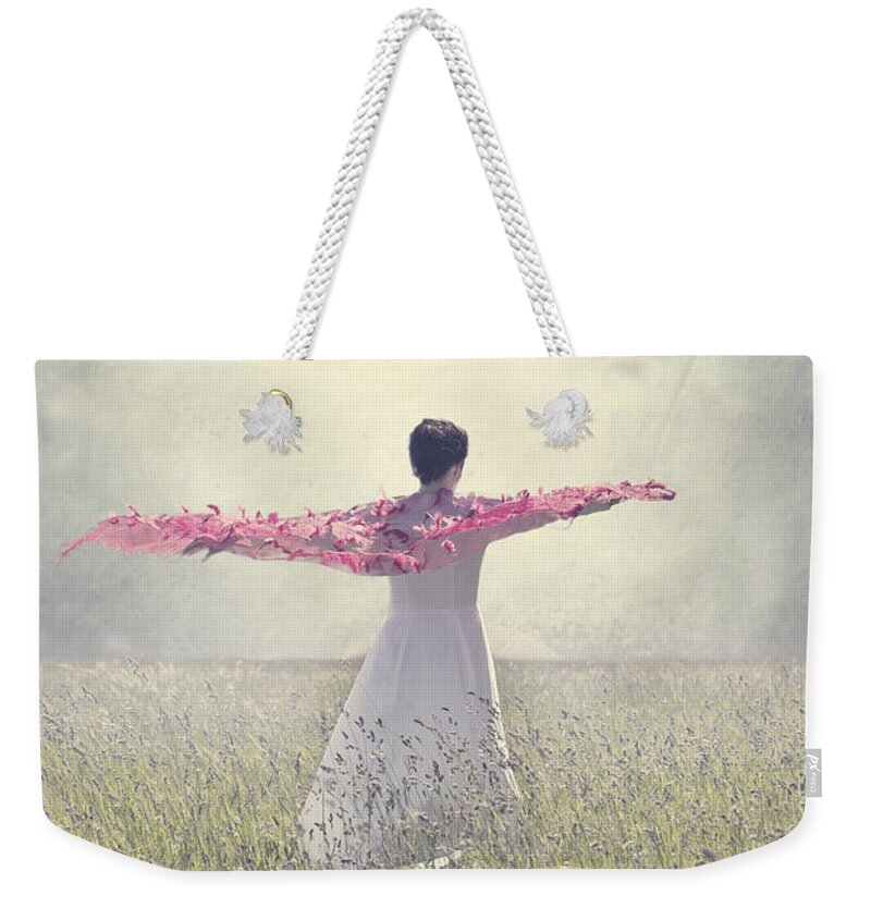 Female Weekender Tote Bag featuring the photograph Woman On A Lawn by Joana Kruse