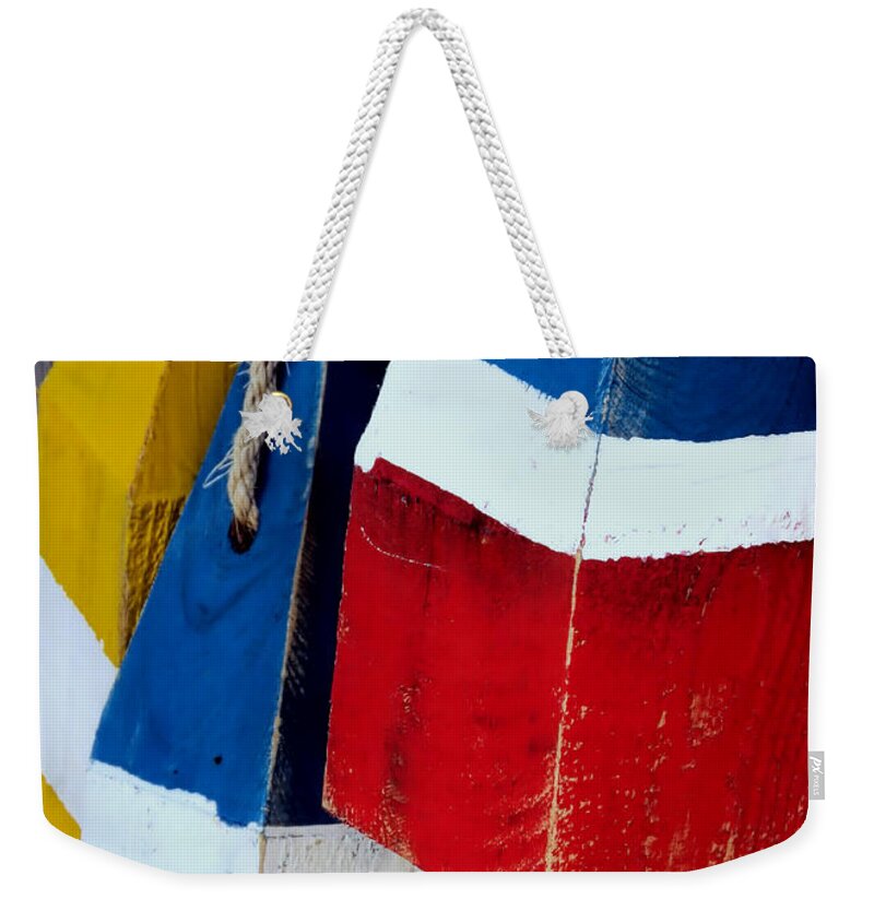 Striped Buoys Weekender Tote Bag featuring the photograph Yellow White Blue Red by Janice Drew