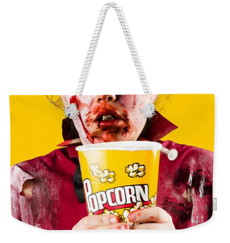 Scary Weekender Tote Bag featuring the photograph Zombie woman watching scary movie with popcorn by Jorgo Photography