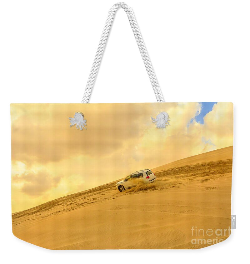 Dune Bashing Weekender Tote Bag featuring the photograph Dune Bashing desert safari #1 by Benny Marty