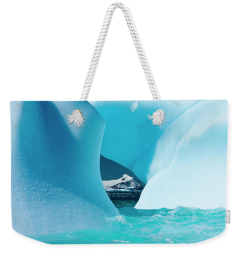 Melting Weekender Tote Bag featuring the photograph Floating Icebergs Framing A View Of The #1 by Mint Images/ Art Wolfe