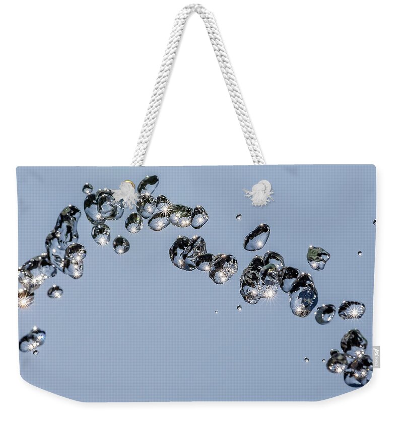 Wolfgang Stocker Weekender Tote Bag featuring the photograph Flying drops #1 by Wolfgang Stocker