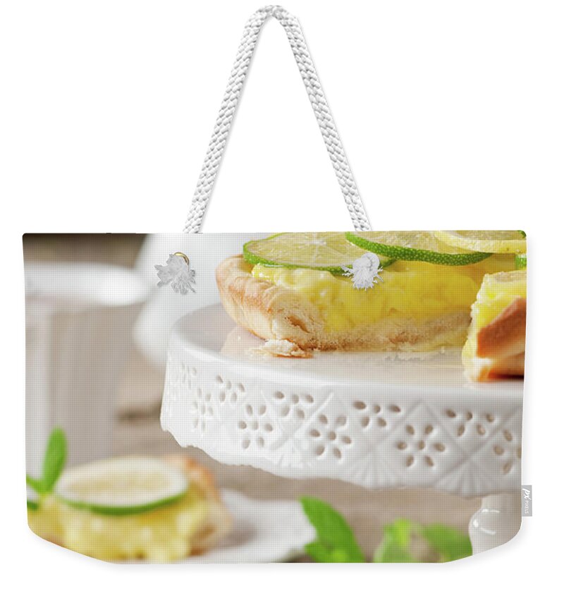 Teapot Weekender Tote Bag featuring the photograph Lime And Lemone Tart #1 by Oxana Denezhkina