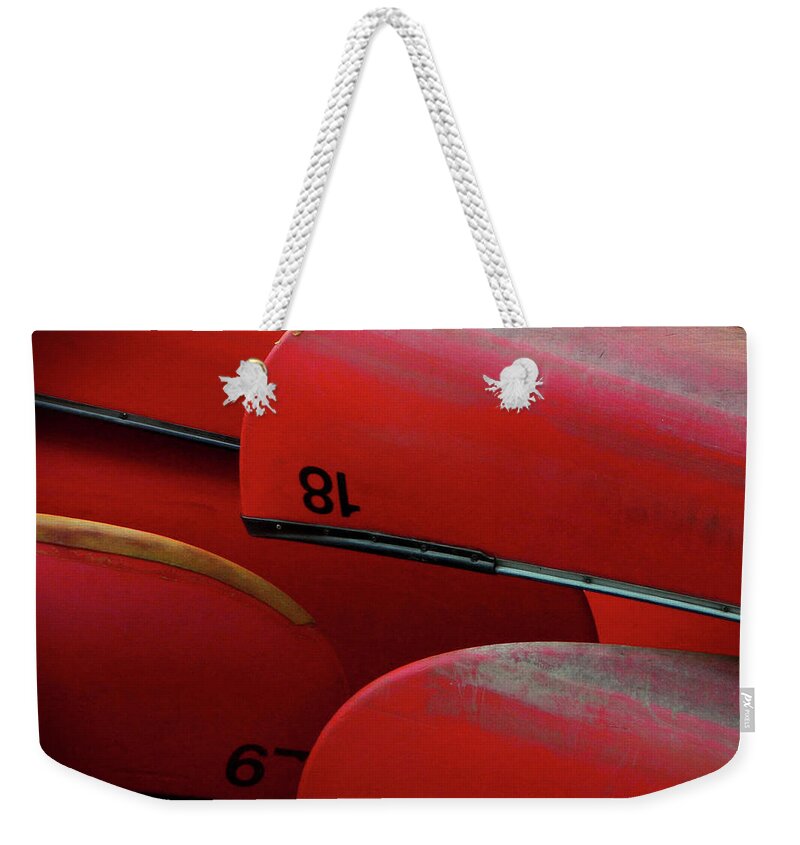 Tranquility Weekender Tote Bag featuring the photograph Red Canoes #1 by Anne Mcdonald