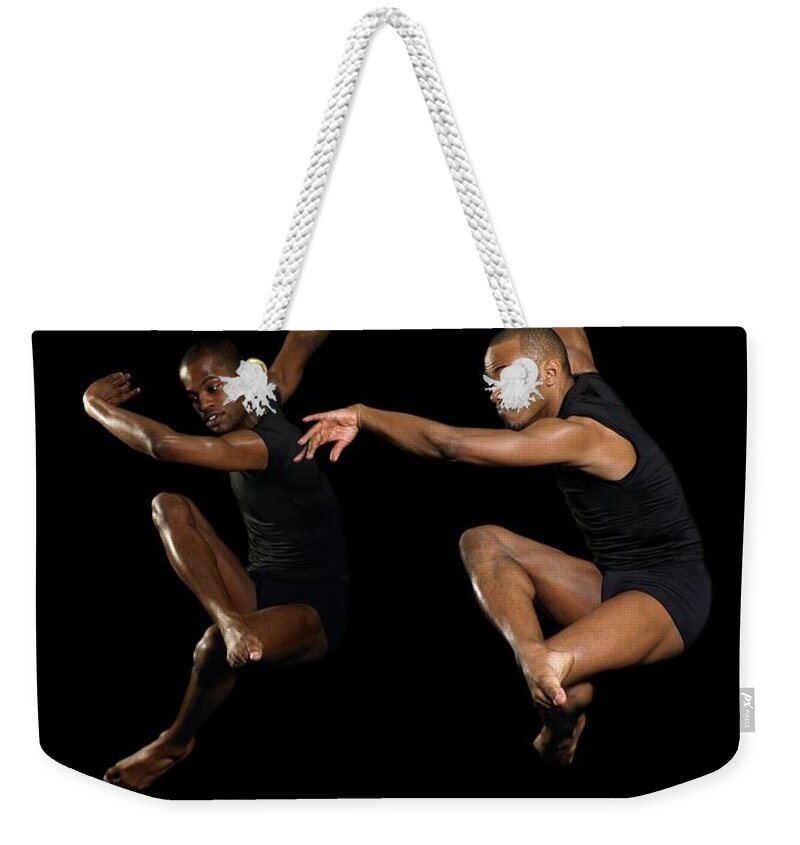 Young Men Weekender Tote Bag featuring the photograph Two Male Dancers Jumping #1 by Image Source