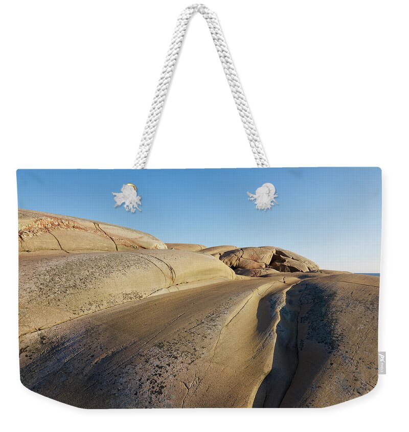 Scenics Weekender Tote Bag featuring the photograph View Of Rocky Coastline #1 by Johner Images
