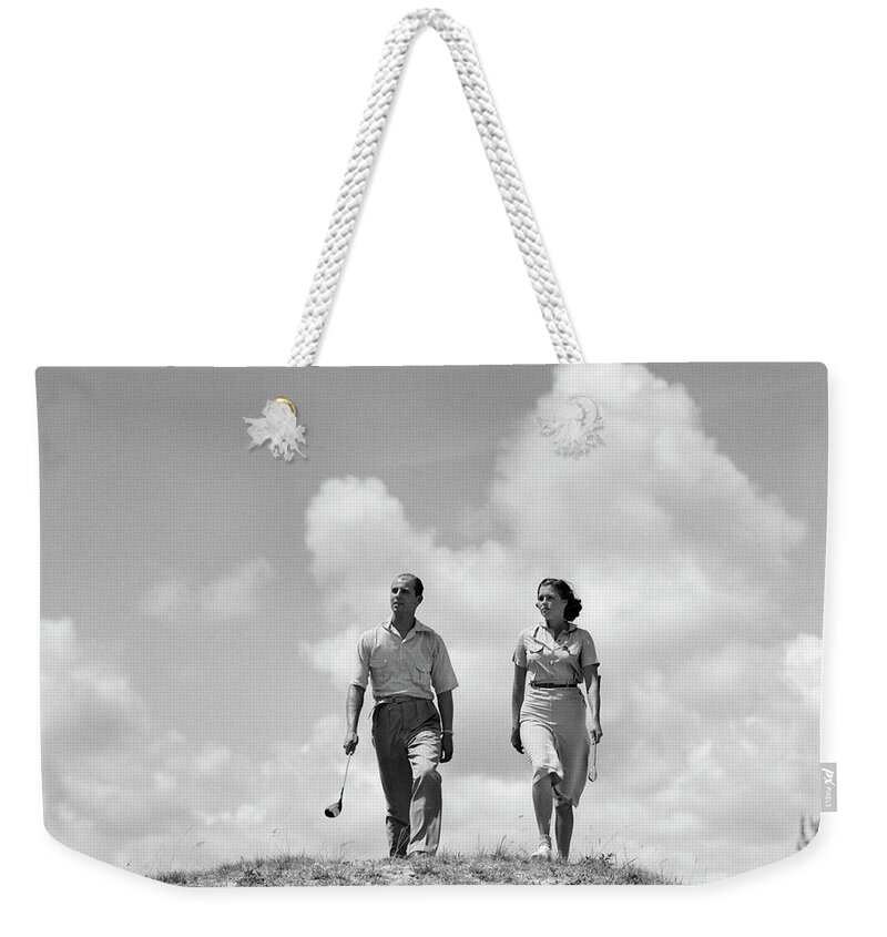 Photography Weekender Tote Bag featuring the photograph 1930s Couple Man Woman Golfers Walking by Vintage Images