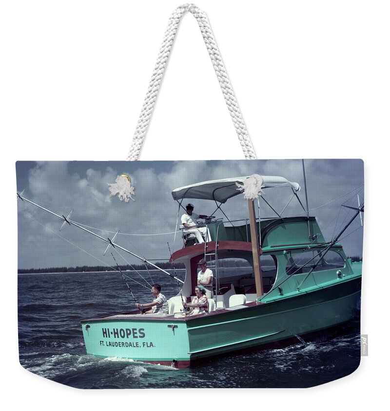 Photograph Weekender Tote Bag featuring the painting 1950s Man Woman Fishing Off Back Stern by Vintage Images