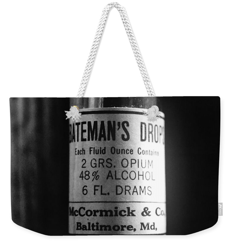 Bateman's Drops Weekender Tote Bag featuring the photograph Antique McCormick and Co Baltimore MD Bateman's Drops Opium Bottle Label - Black and White by Marianna Mills