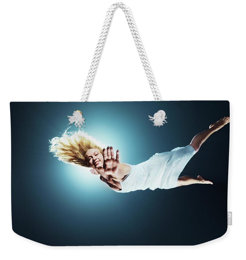 Human Arm Weekender Tote Bag featuring the photograph Young Woman In Air, Arms Outstretched #2 by Henrik Sorensen