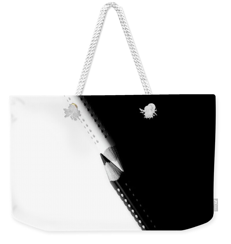 Education Weekender Tote Bag featuring the photograph Two drawing pencils on a black and white surface. by Michalakis Ppalis