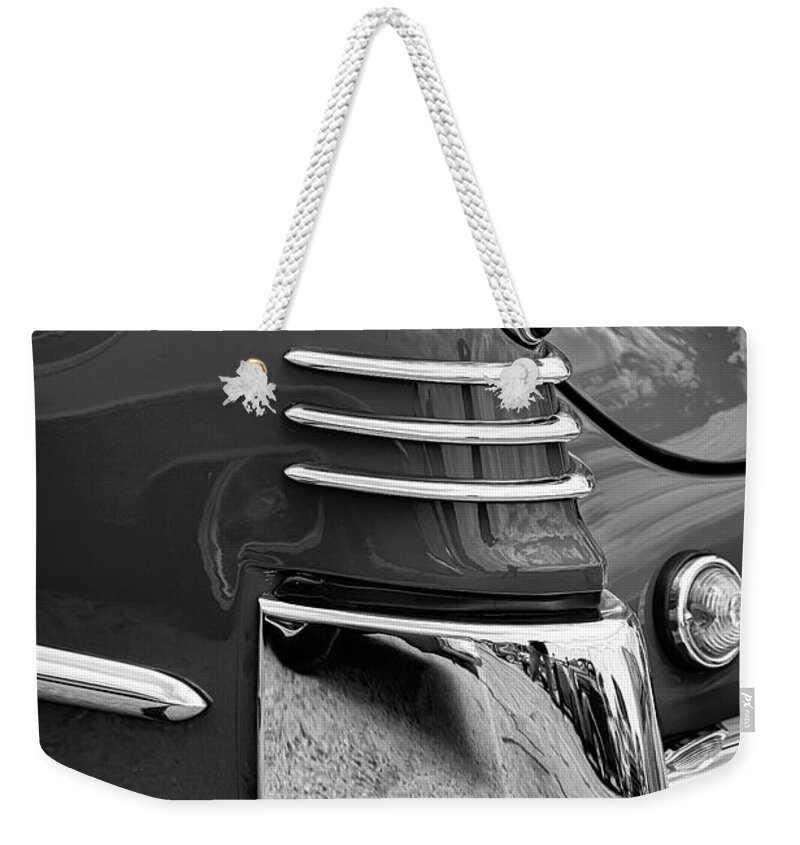 1948 Weekender Tote Bag featuring the photograph '48 Cadillac Taillight #48 by Dennis Hedberg