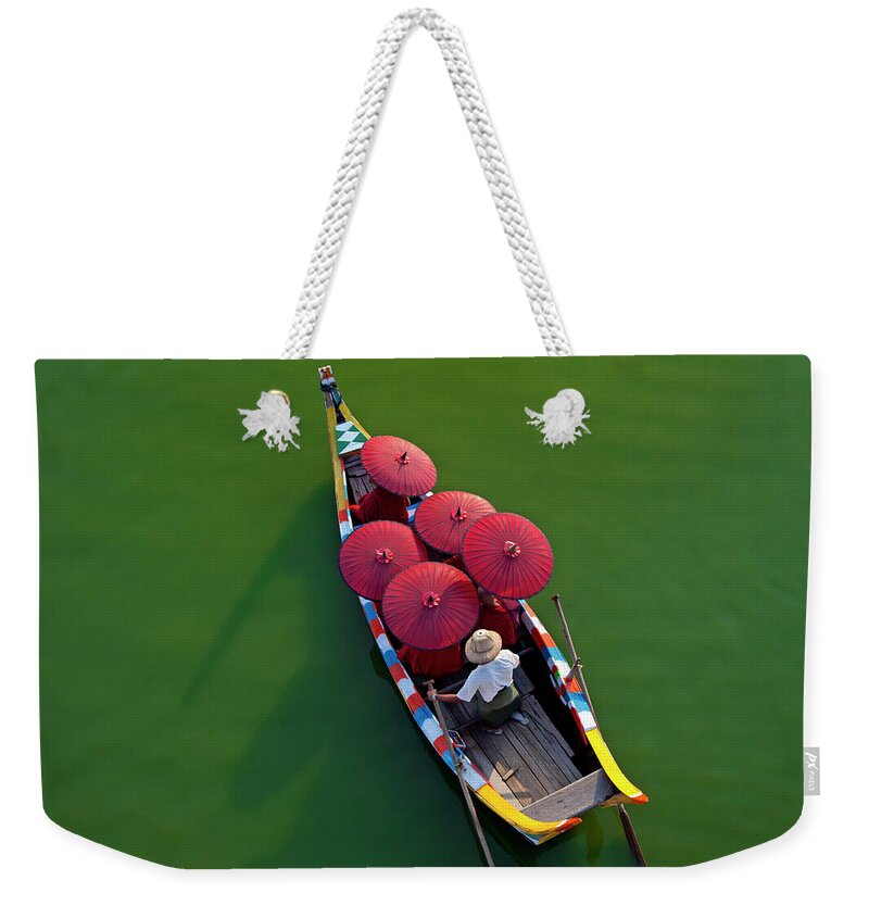 Southeast Asia Weekender Tote Bag featuring the photograph A Dug Out Canoe On The Rivers Of The by Mint Images - Art Wolfe