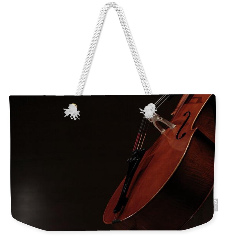 Mature Adult Weekender Tote Bag featuring the photograph A Female Cellist Playing Cello On by Sot