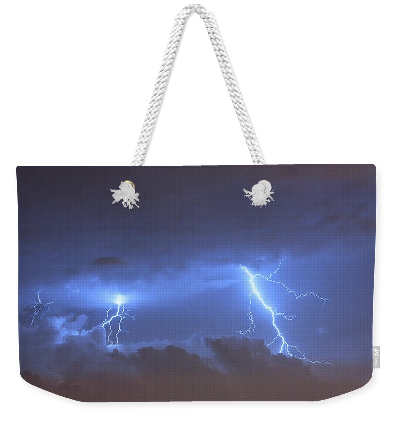 Environmental Damage Weekender Tote Bag featuring the photograph A Lightning Strikes From The Sky During by Nature247