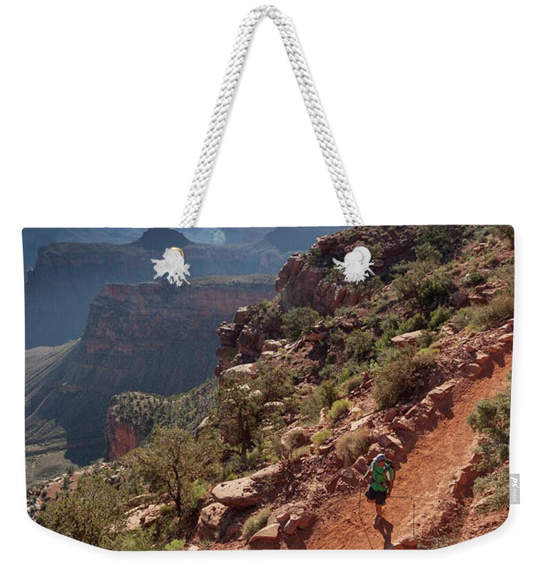 Tranquility Weekender Tote Bag featuring the photograph A Man Hiking On A Trail With Canyons In by Whit Richardson