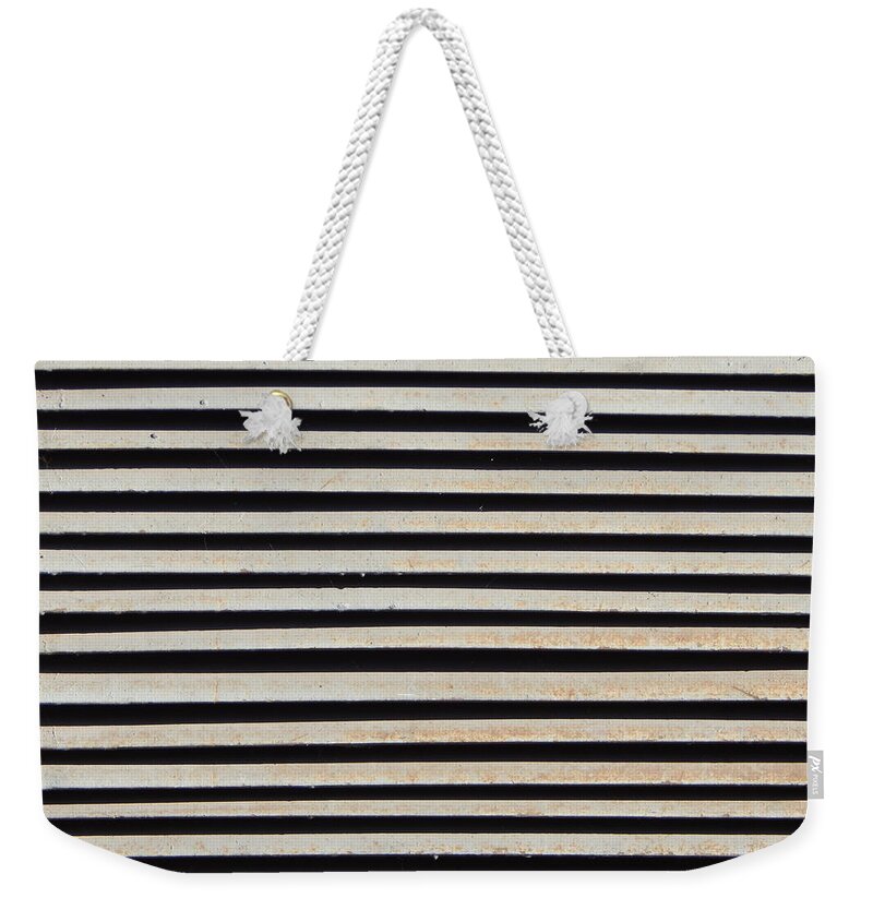 Metal Weekender Tote Bag featuring the photograph A metal grill texture for construction and windows by Oleg Prokopenko