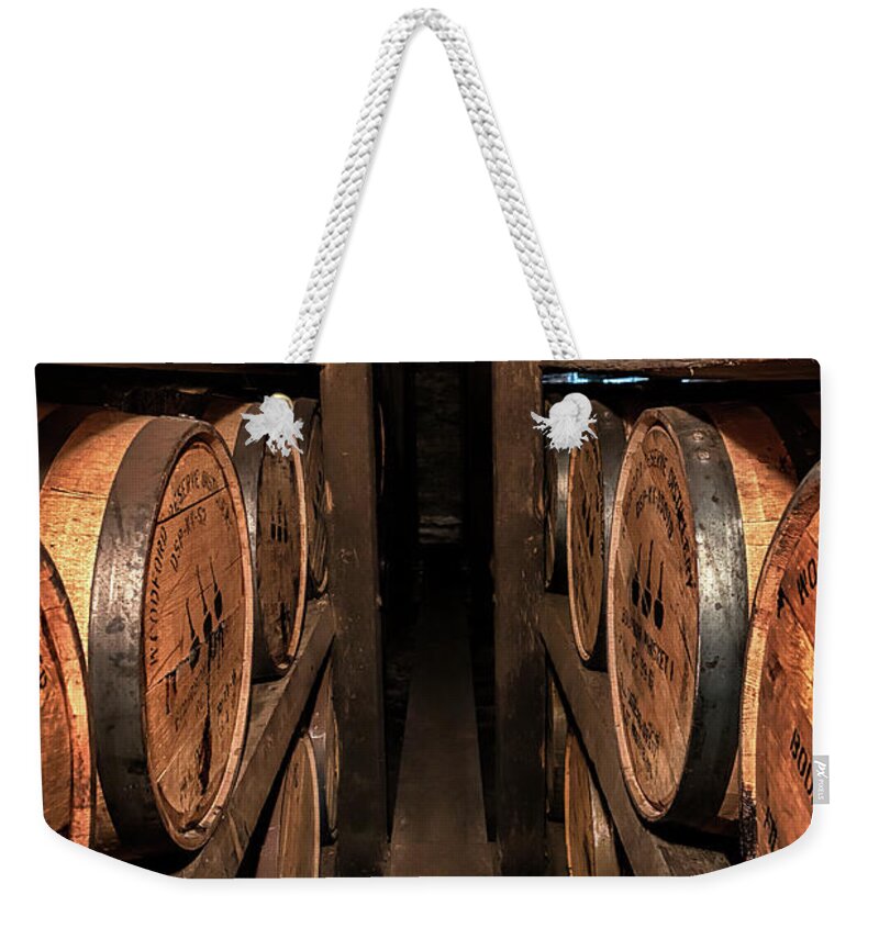 Woodford Reserve Weekender Tote Bag featuring the photograph A Peek Between the Ricks by Susan Rissi Tregoning