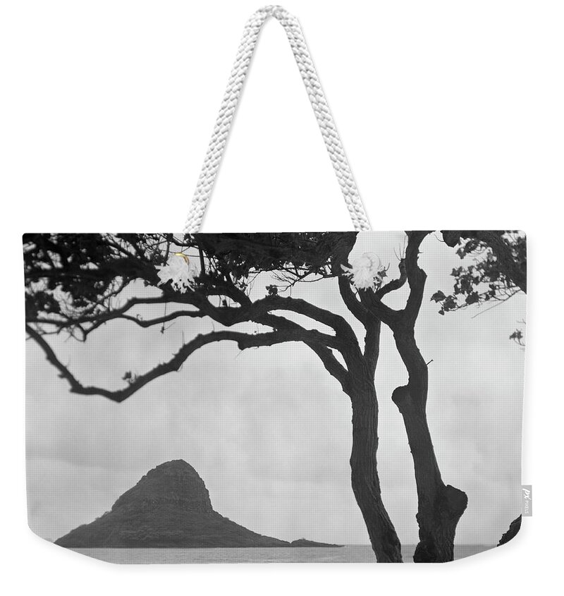 Scenics Weekender Tote Bag featuring the photograph A Rock Formation In The Pacific Ocean by Brian Caissie