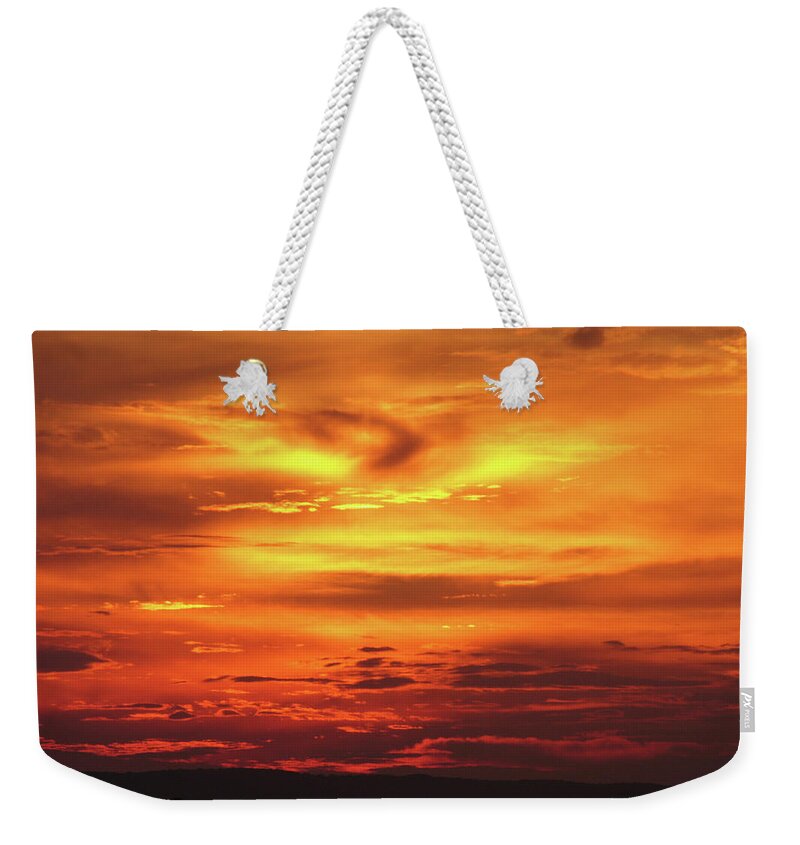 Majestic Weekender Tote Bag featuring the photograph A Vivid Orange And Red Sunset Over by Jlfcapture