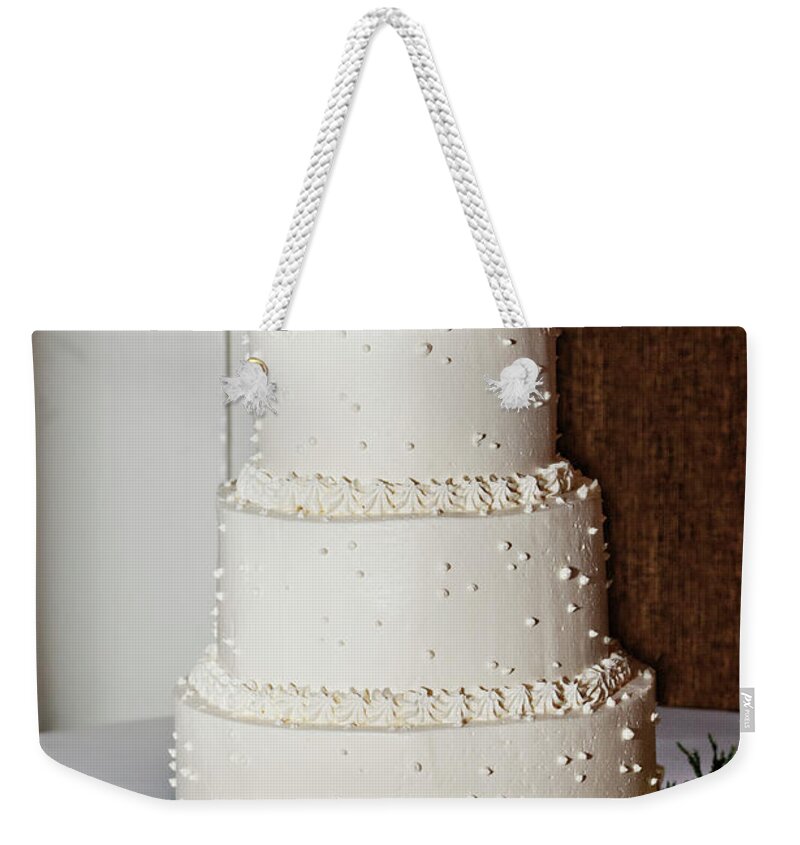 Temptation Weekender Tote Bag featuring the photograph A Wedding Cake Trimed In Peach Roses by Driendl Group