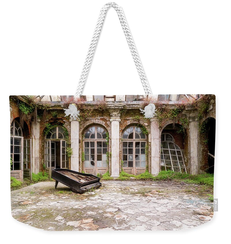 Urban Weekender Tote Bag featuring the photograph Abandoned Piano in Courtyard by Roman Robroek