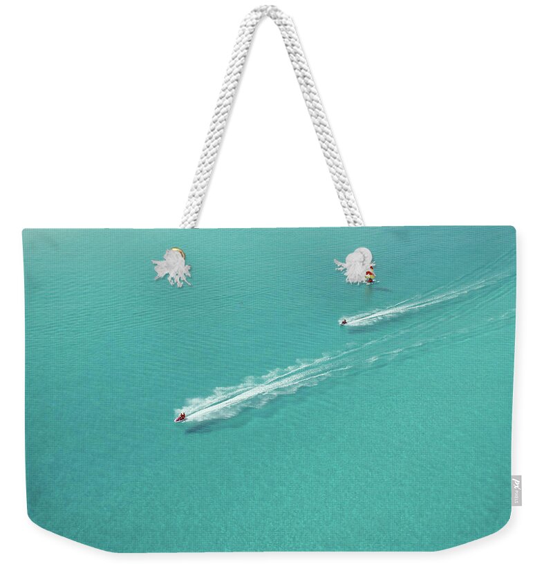 Wake Weekender Tote Bag featuring the photograph Aerial View Of Racing Watercraft Off by Jupiterimages