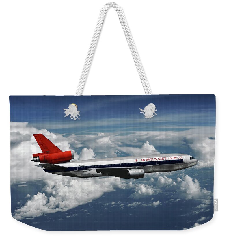 Northwest Orient Airlines Weekender Tote Bag featuring the mixed media Among the Clouds - Northwest Orient DC-10-40 by Erik Simonsen
