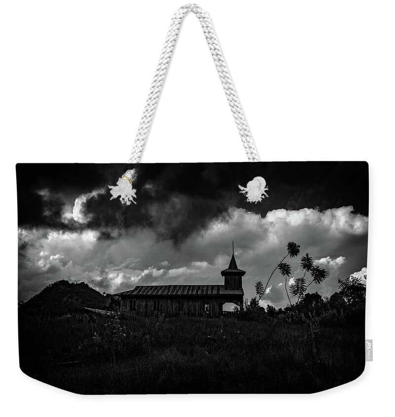 Church Weekender Tote Bag featuring the photograph Ancient Wooden Church With Storm Clouds by Chris Lord