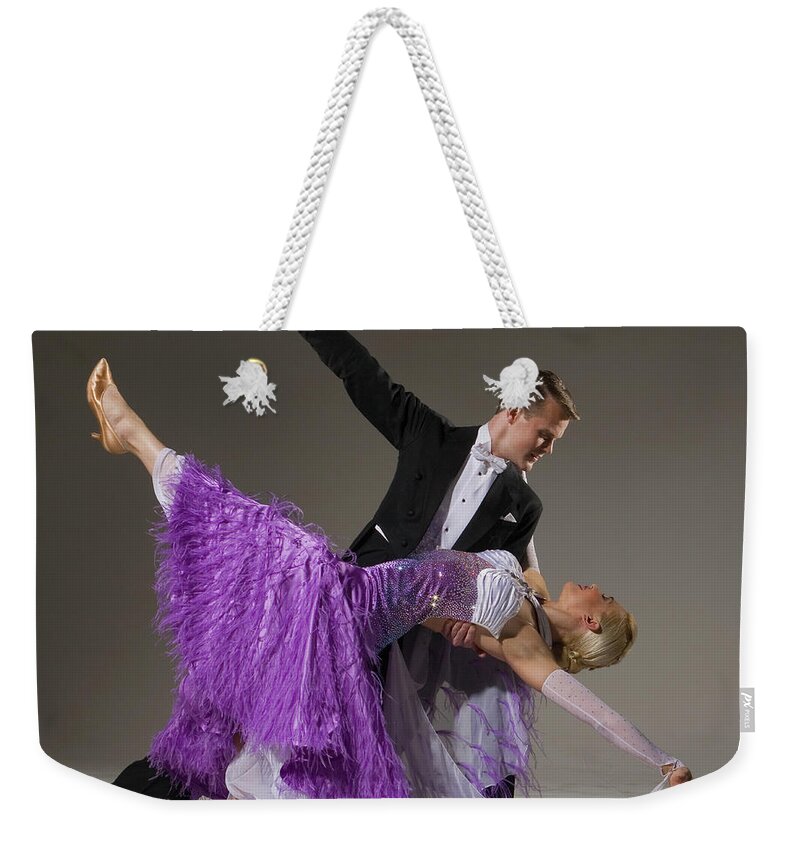 Teamwork Weekender Tote Bag featuring the photograph Ballroom Dancing Pair Performing Dip by Pm Images
