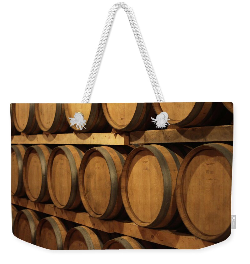 Aging Process Weekender Tote Bag featuring the photograph Barrels Of Wine In Cellar by Tom And Steve