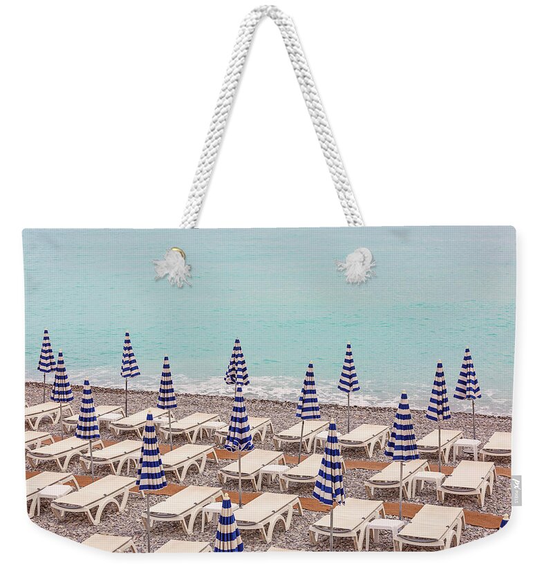 Beach Umbrellas In Nice Weekender Tote Bag featuring the photograph Beach Umbrellas in Nice by Melanie Alexandra Price