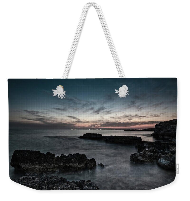 Seascape Weekender Tote Bag featuring the photograph Beautiful dramatic Sunset on a rocky coastline by Michalakis Ppalis