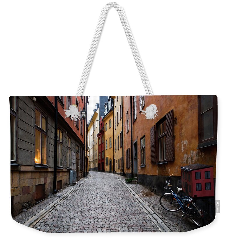 Tranquility Weekender Tote Bag featuring the photograph Bike Standing Near Street by Johan Klovsjö